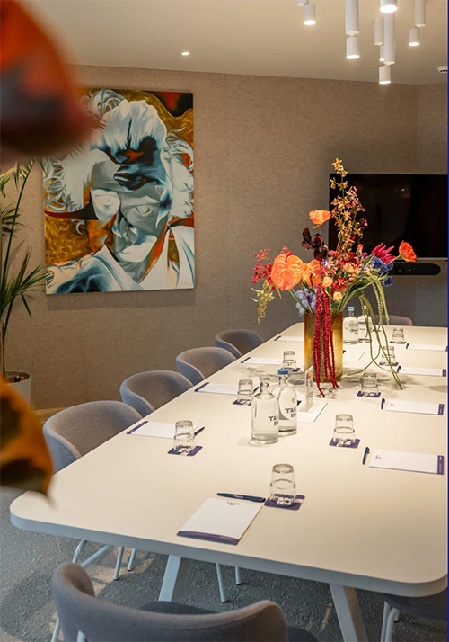 Meeting room at Take In — modern workspace with colorful art and natural light